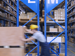 an employee moves parcels in a warehouse