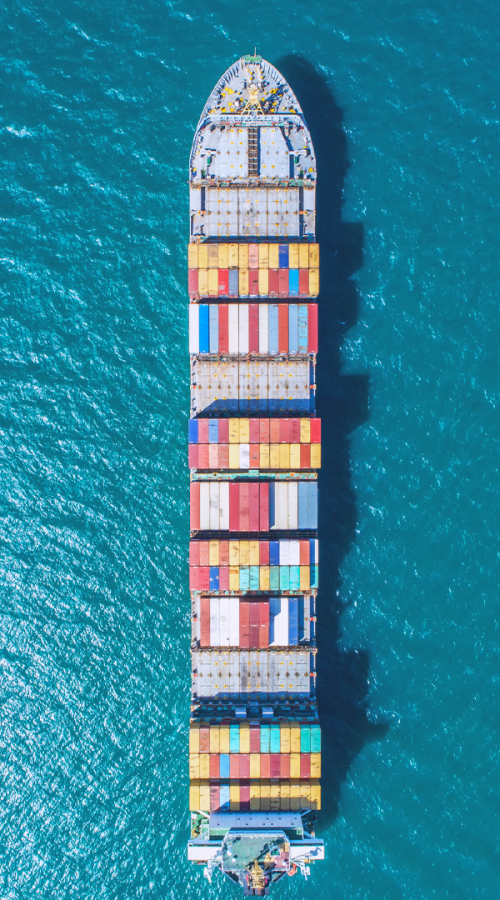 a boat carries containers on the ocean
