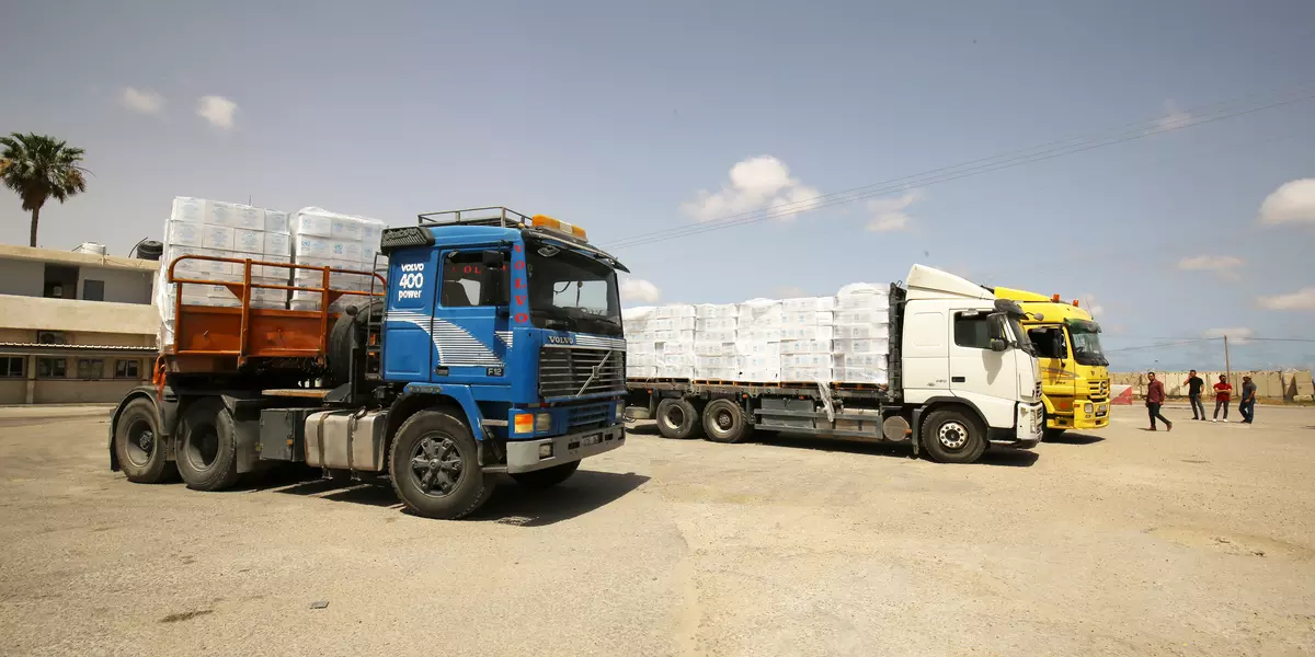 three trucks with human aid