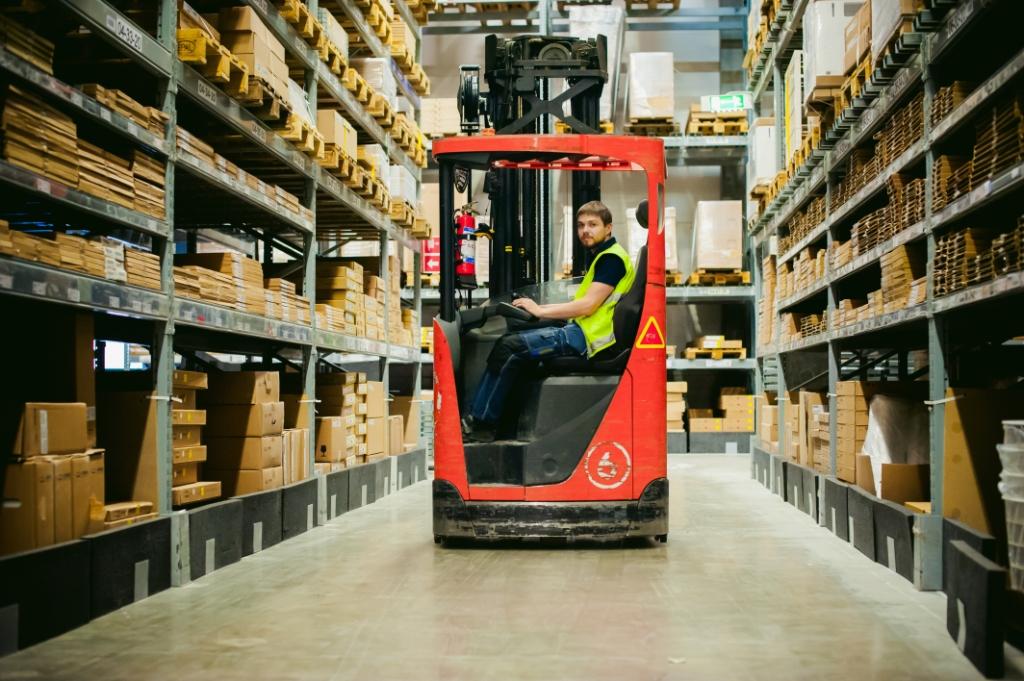 Man on a logistic warehouse reachtruck