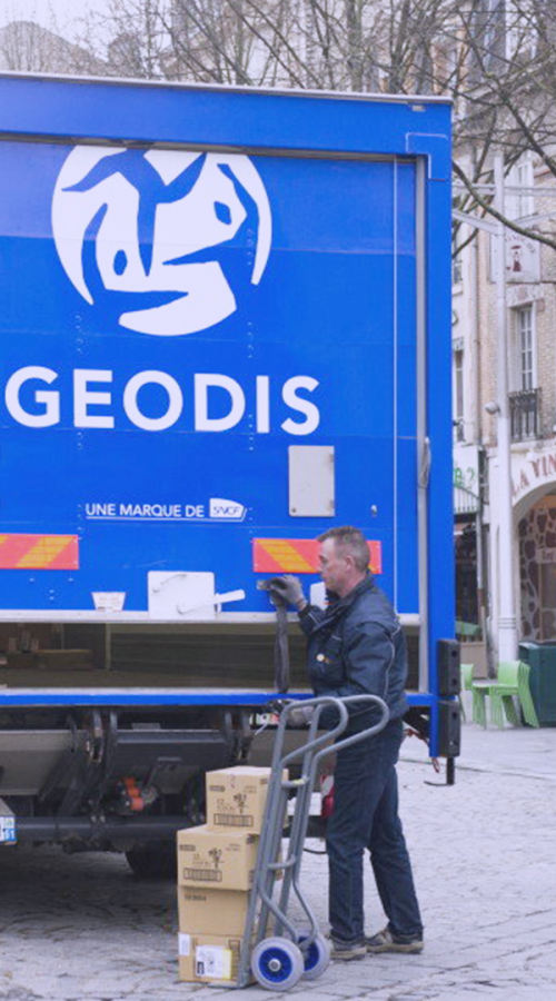 a delivery driver in front of a GEODIS truck